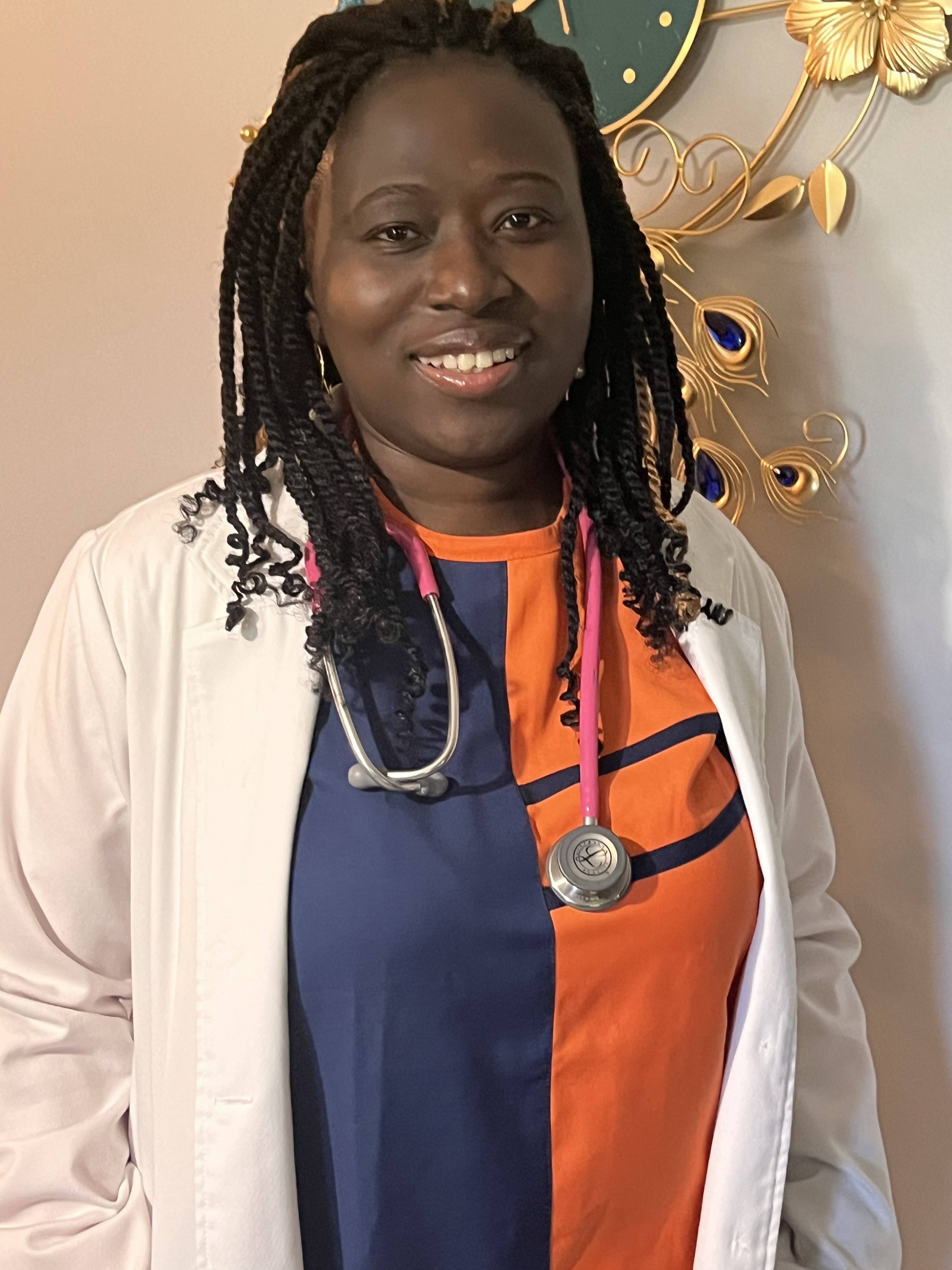 My Hilltop provider smiling in a white clinical coat