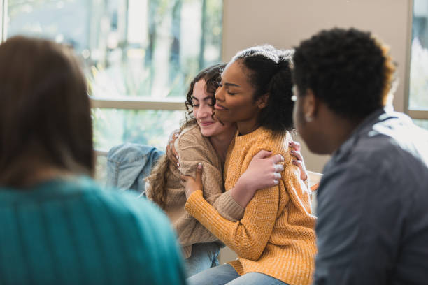 Support group participants sharing a comforting hug