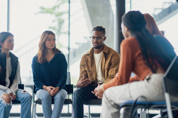 Young adults participating in a guided group therapy conversation