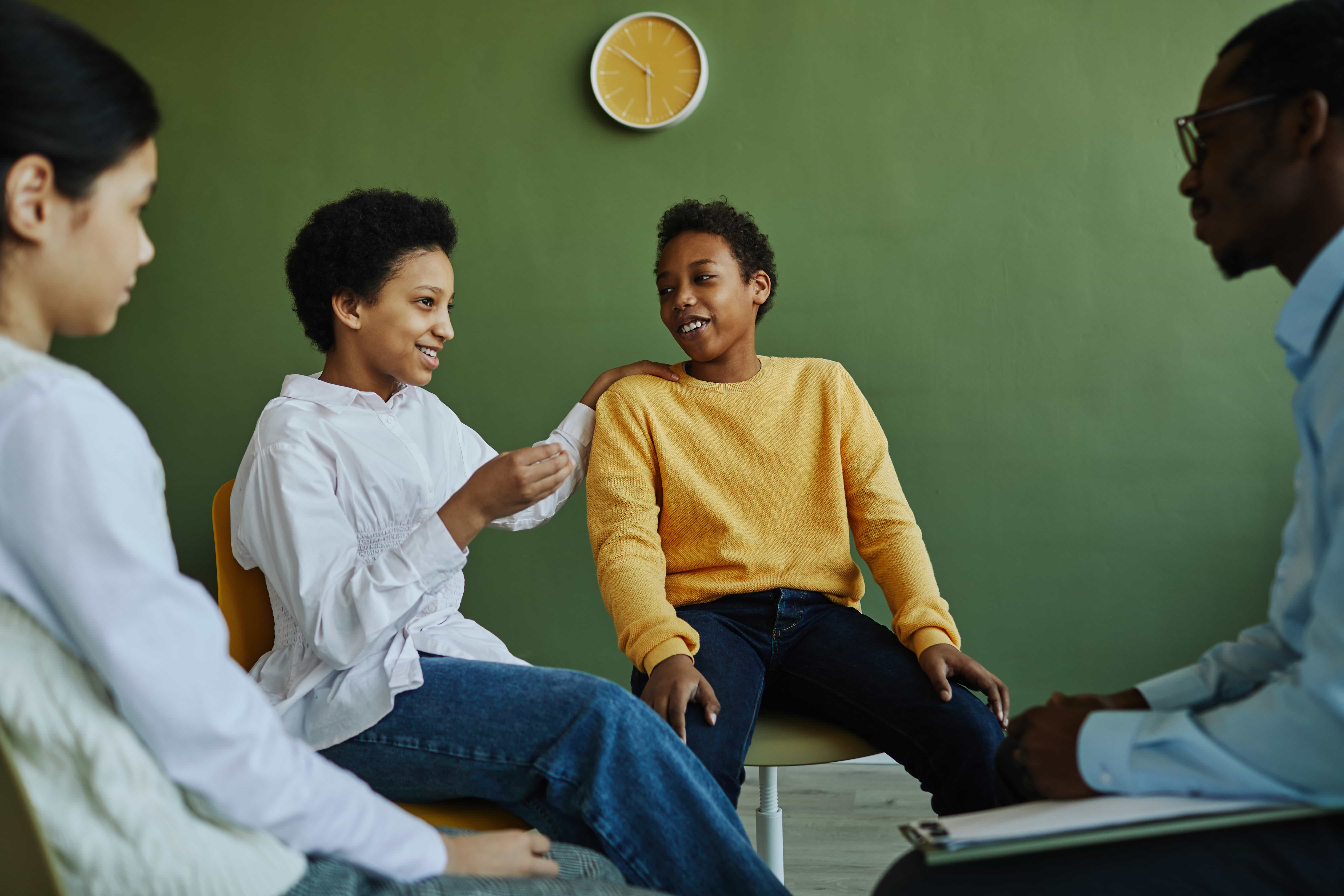 Children talking with a counselor in a calm therapy room