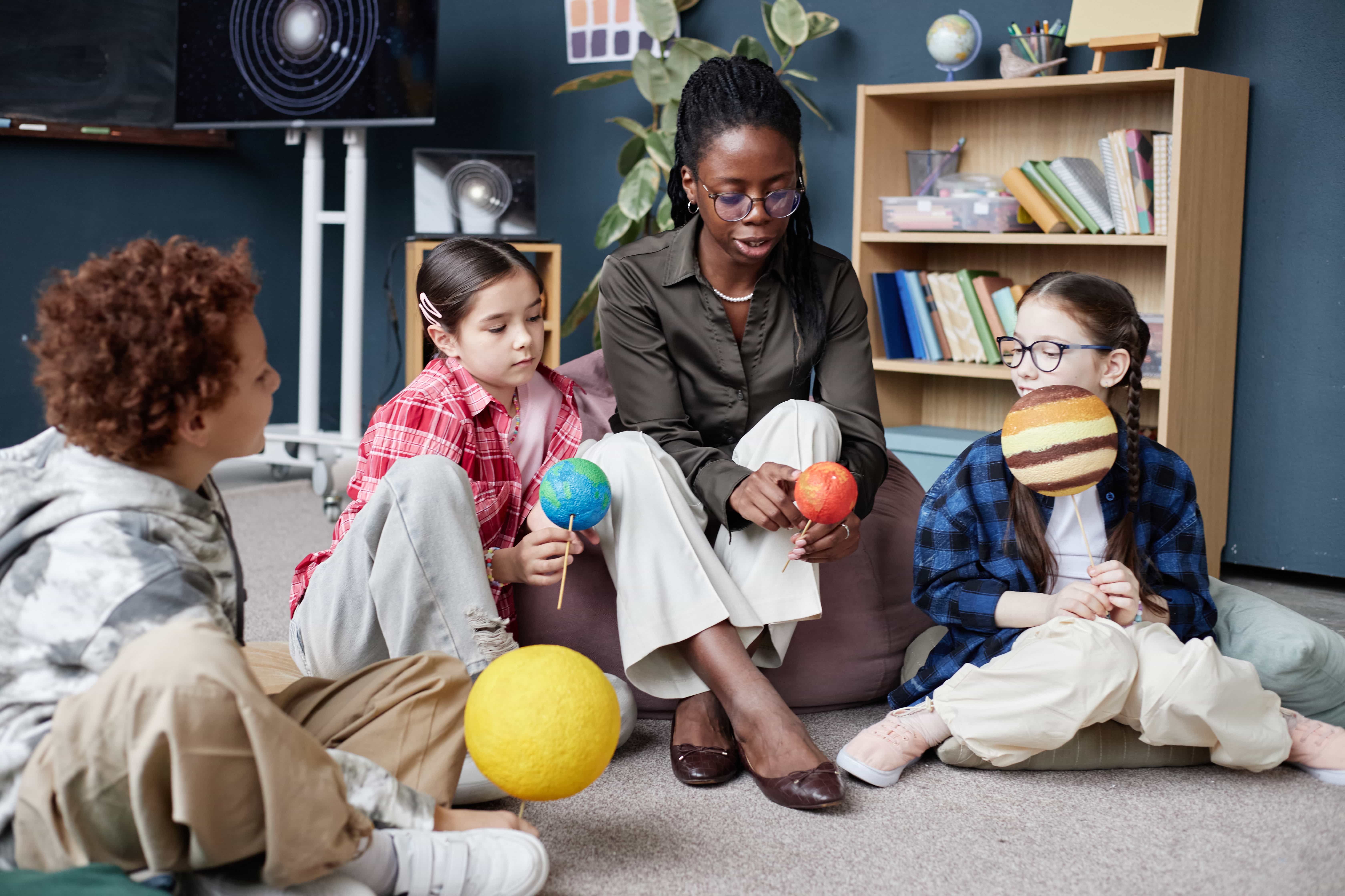 Children learning with a therapist in a classroom setting