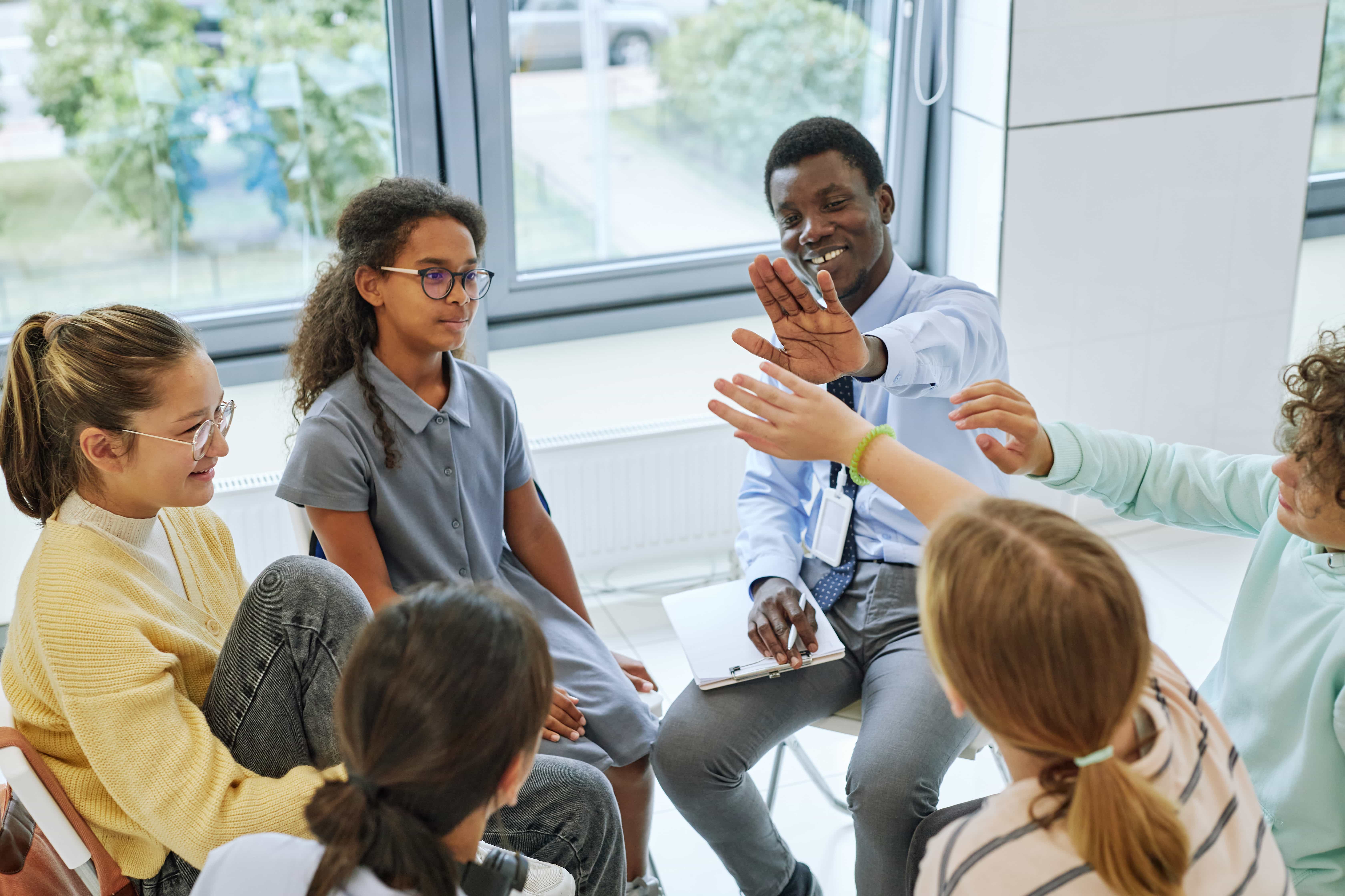 Counselor leading a youth group activity