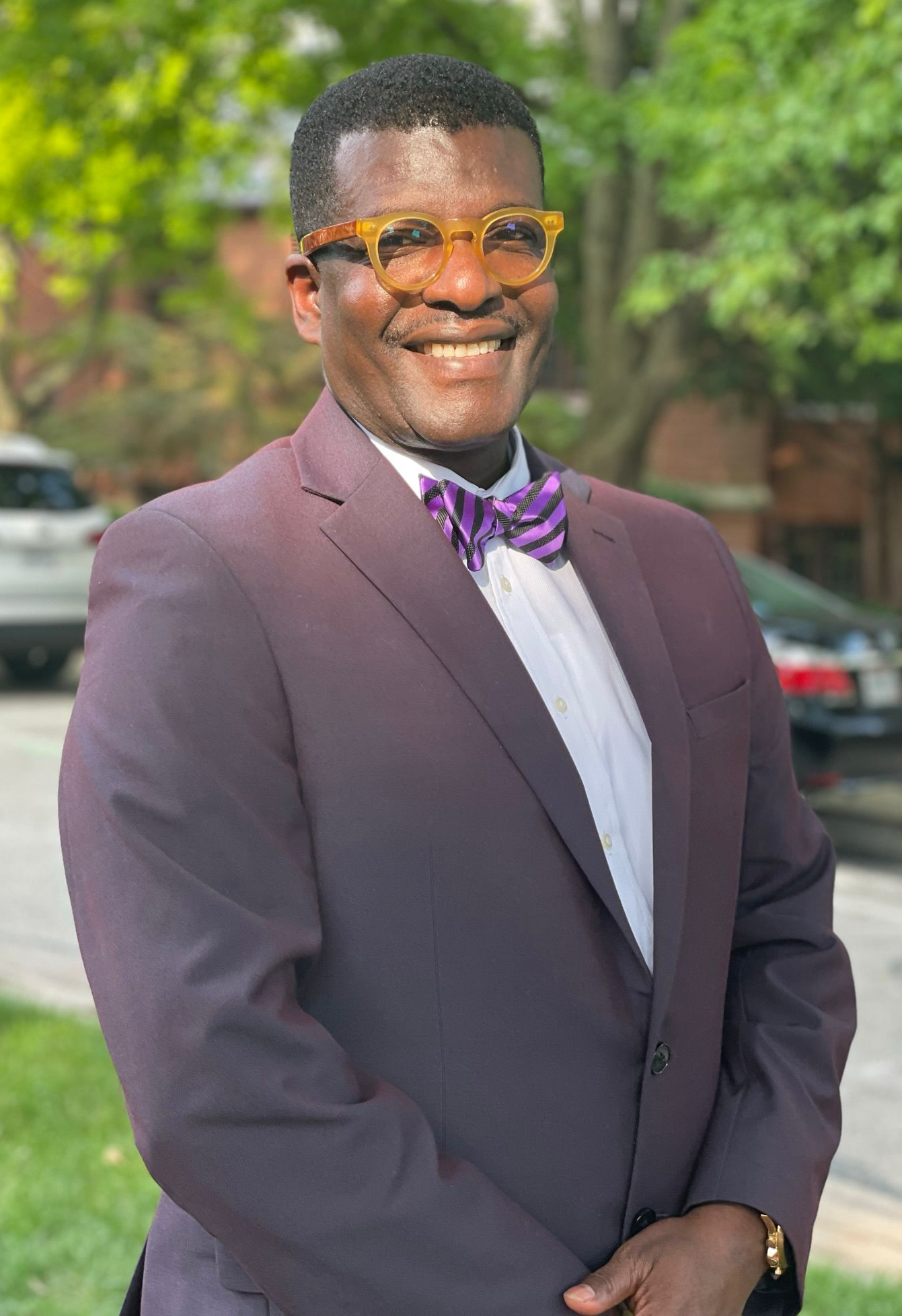 My Hilltop team member smiling outdoors in a suit